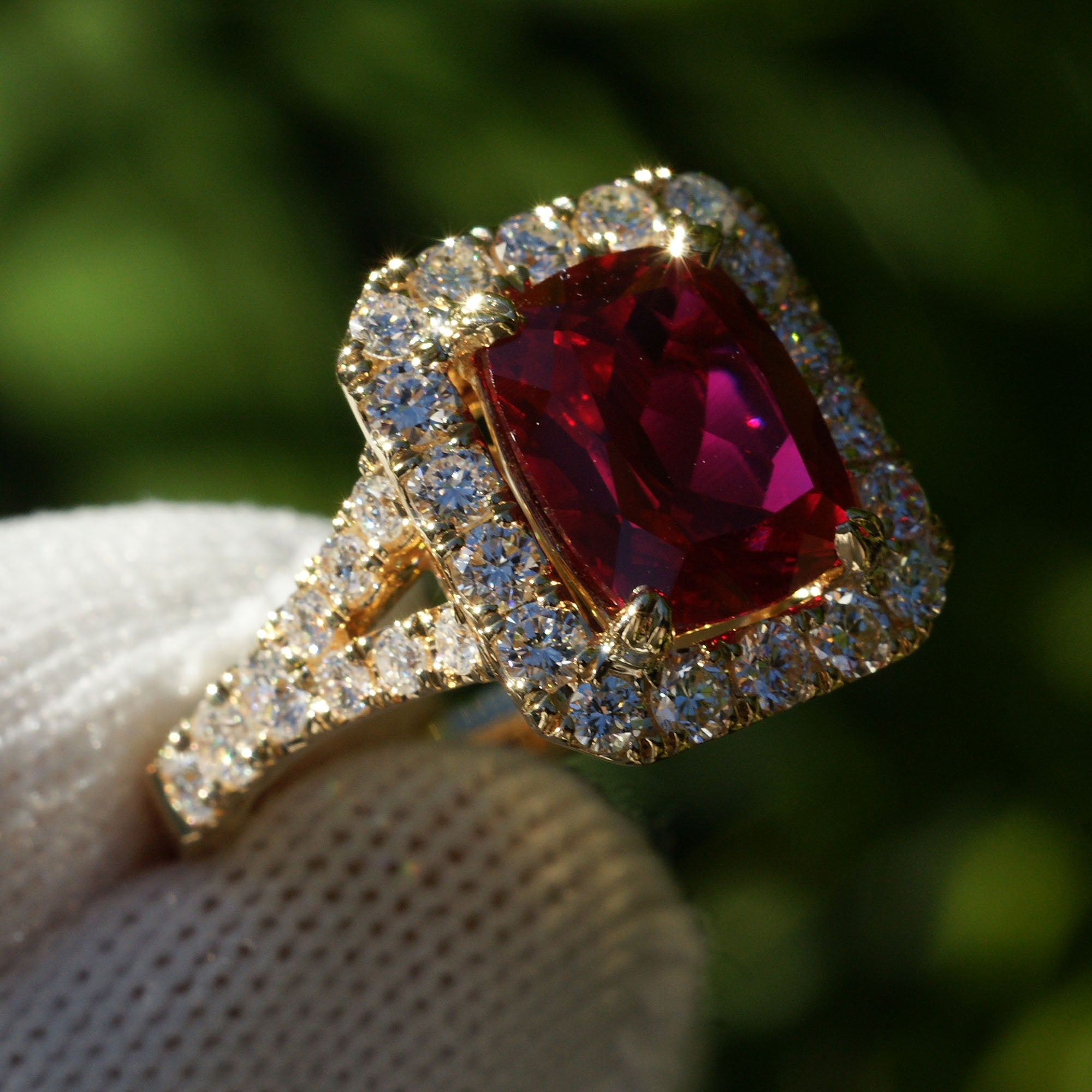Cushion ruby with large diamond halo engagement ring with split band in yellow gold 10x8mm