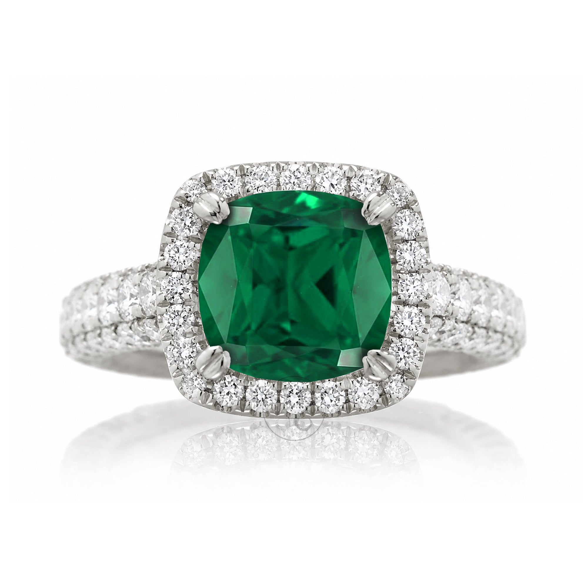 Cushion-cut emerald engagement ring in white gold with diamond halo and pavé diamond shoulders The Tamara