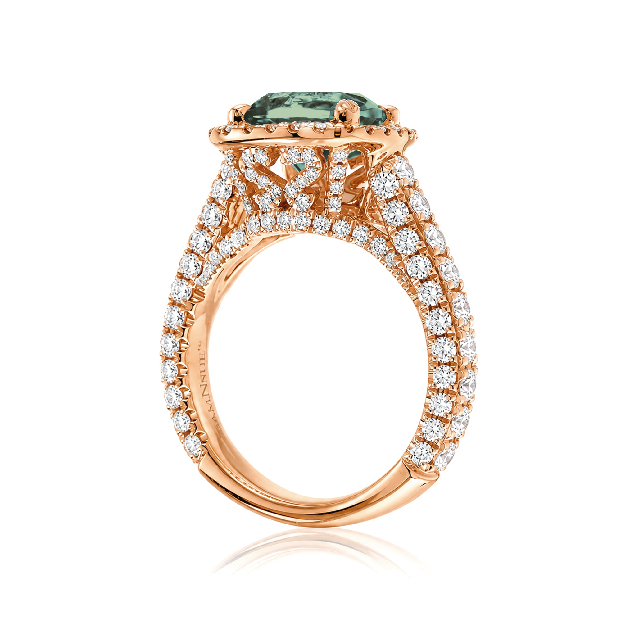 Cushion-cut green sapphire engagement ring in rose gold with diamond halo and pavé diamond shoulders