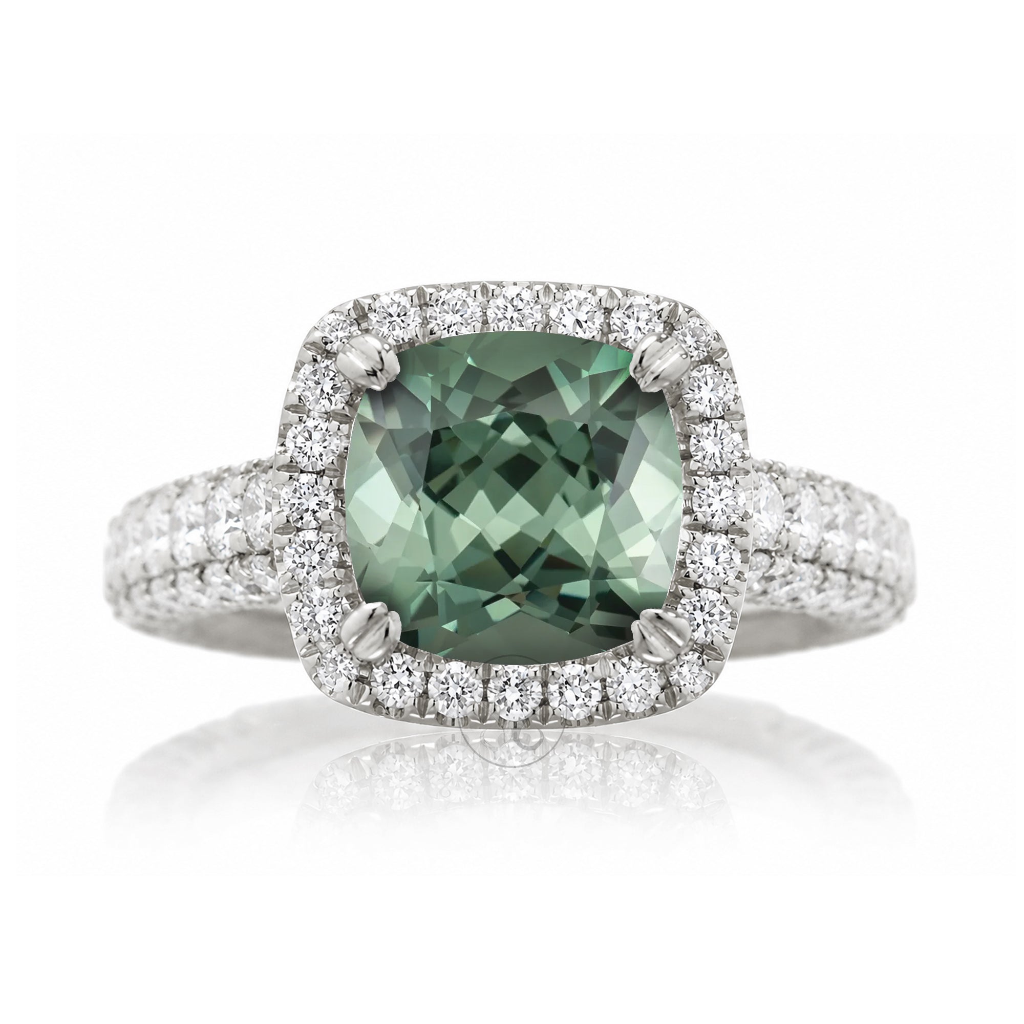Cushion-cut green sapphire engagement ring in white gold with diamond halo and pavé diamond shoulders