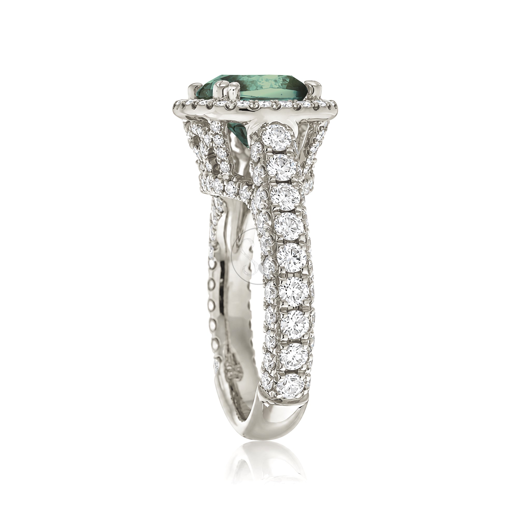 Cushion-cut green sapphire engagement ring in white gold with diamond halo and pavé diamond shoulders
