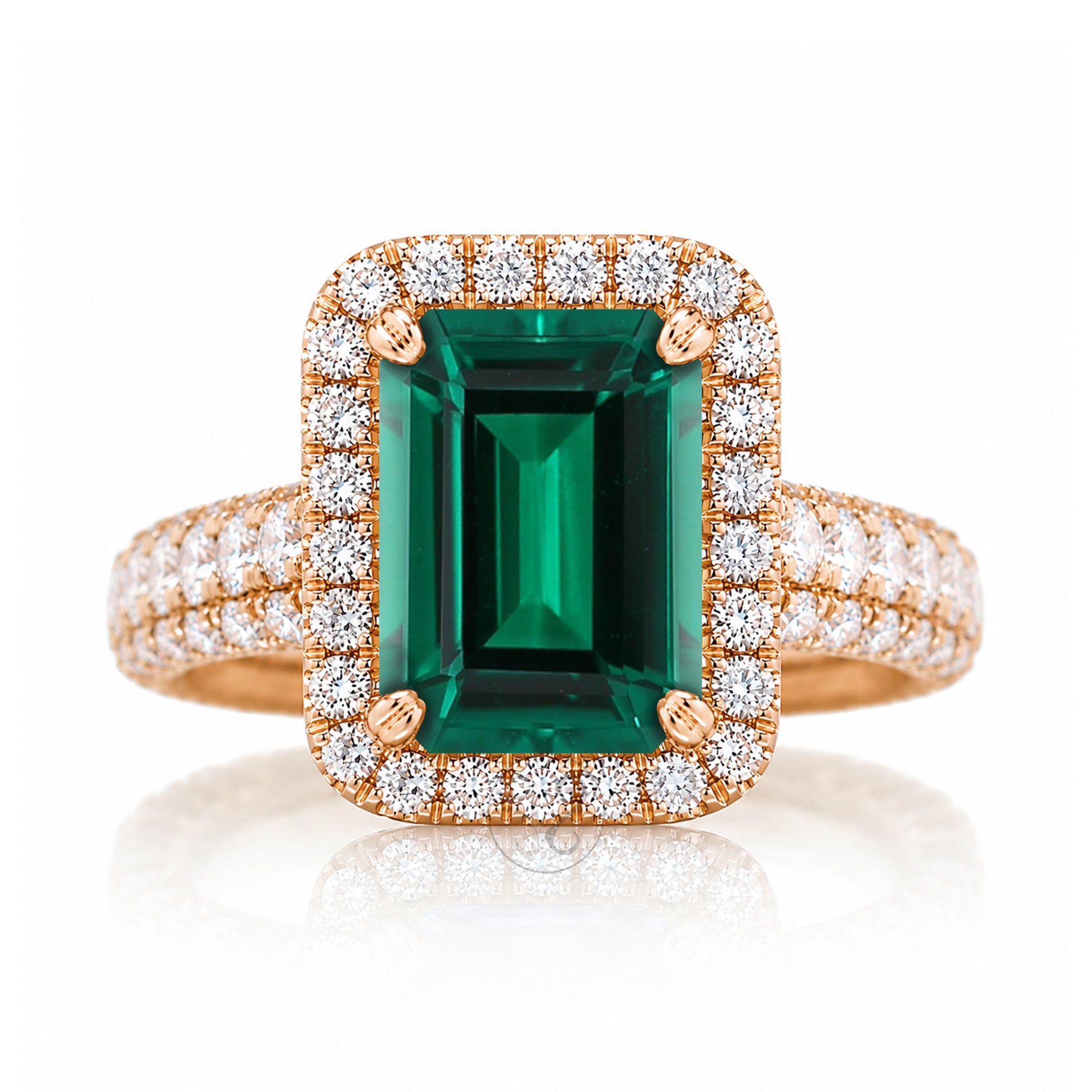 An emerald-cut green gemstone ring with a rose gold halo and diamond-set band three dimensional diamond band thick and bold rose gold
