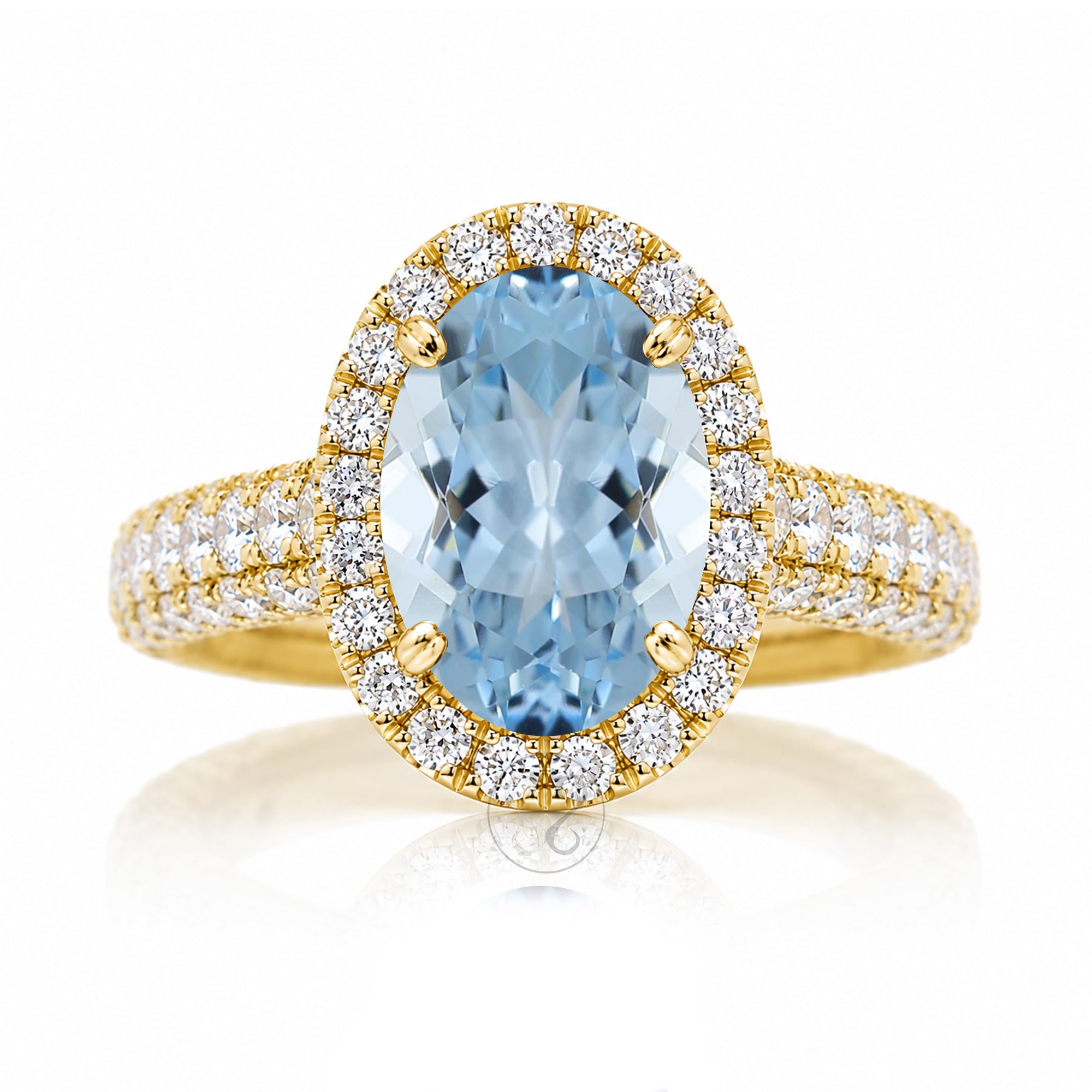 Oval-cut aquamarine engagement ring in yellow gold with diamond halo and pavé diamond shoulders The Tamara