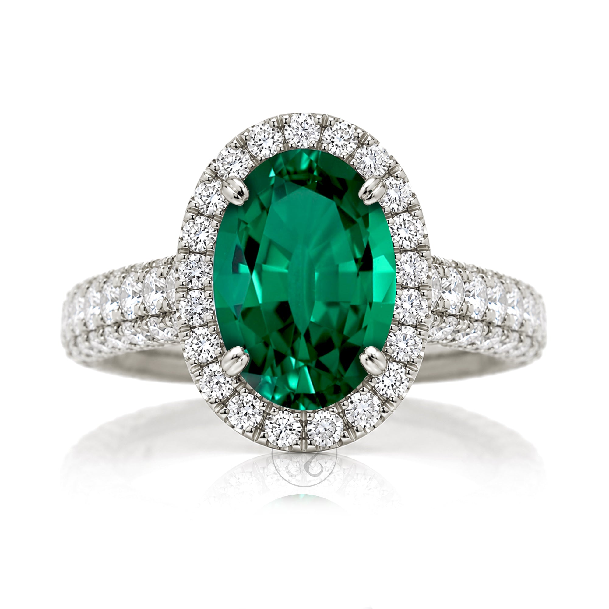 Oval-cut emerald engagement ring in white gold with diamond halo and pavé diamond shoulders The Tamara