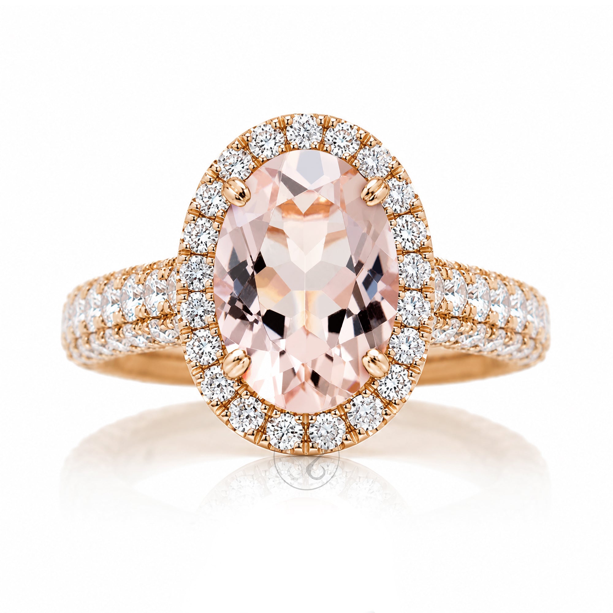 An oval-cut pink morganite halo ring in rose gold, featuring a central peach-pink gemstone surrounded by a double halo of small clear stones and a diamond pavé band The Tamara