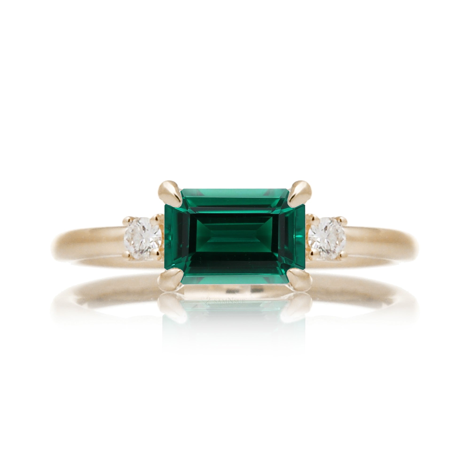 Three Stone side way setting emerald step cut yellow gold ring