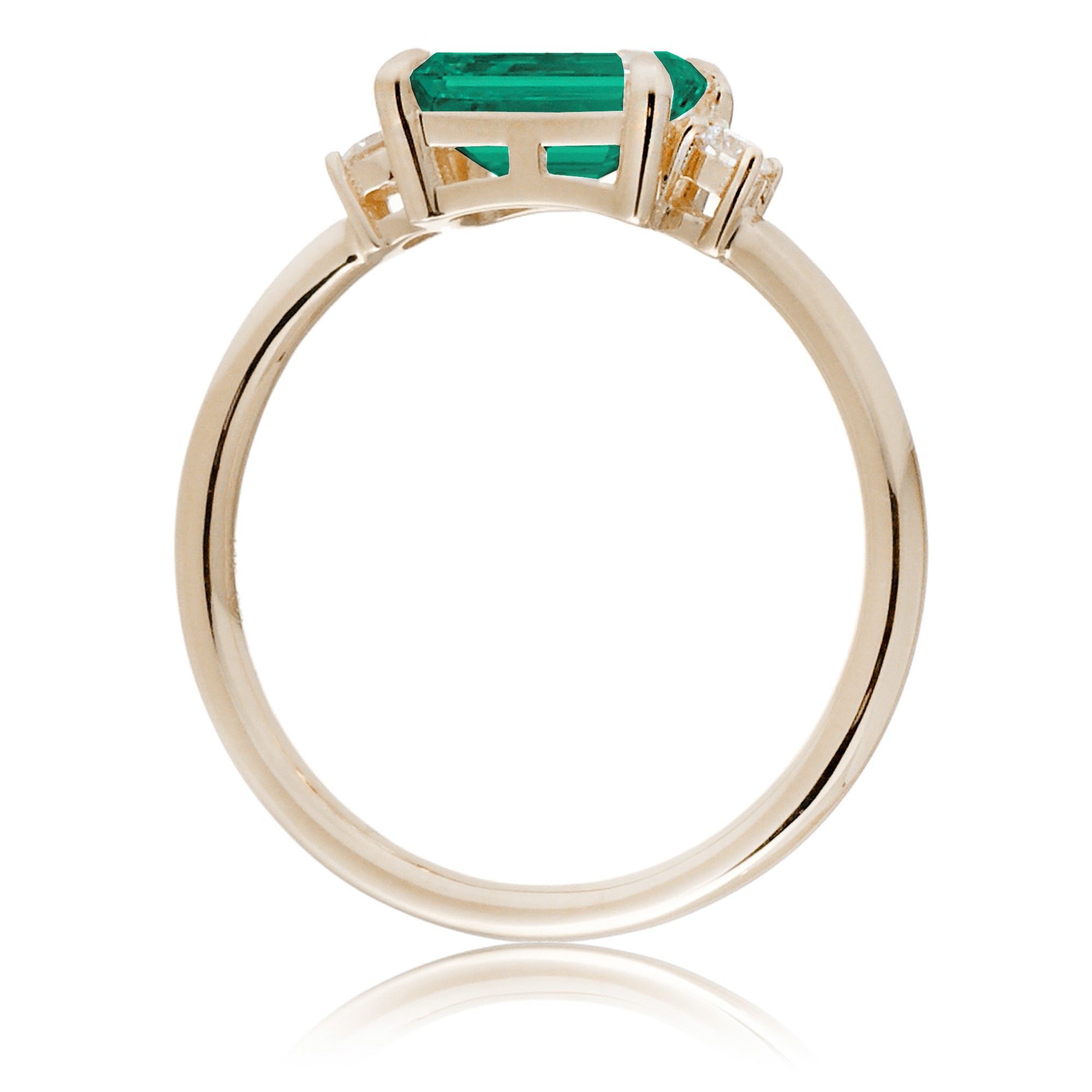 Three Stone side way setting emerald step cut yellow gold ring