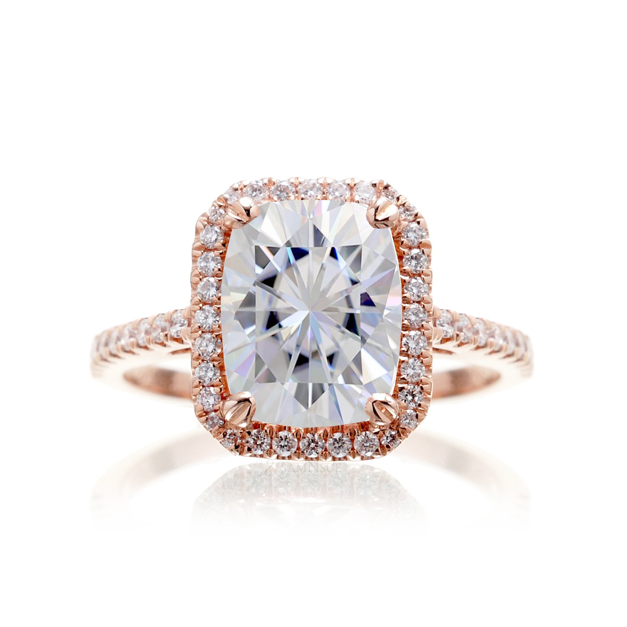 Cushion cut moissanite engagement ring with a diamond halo on the Signature elongated rose gold setting