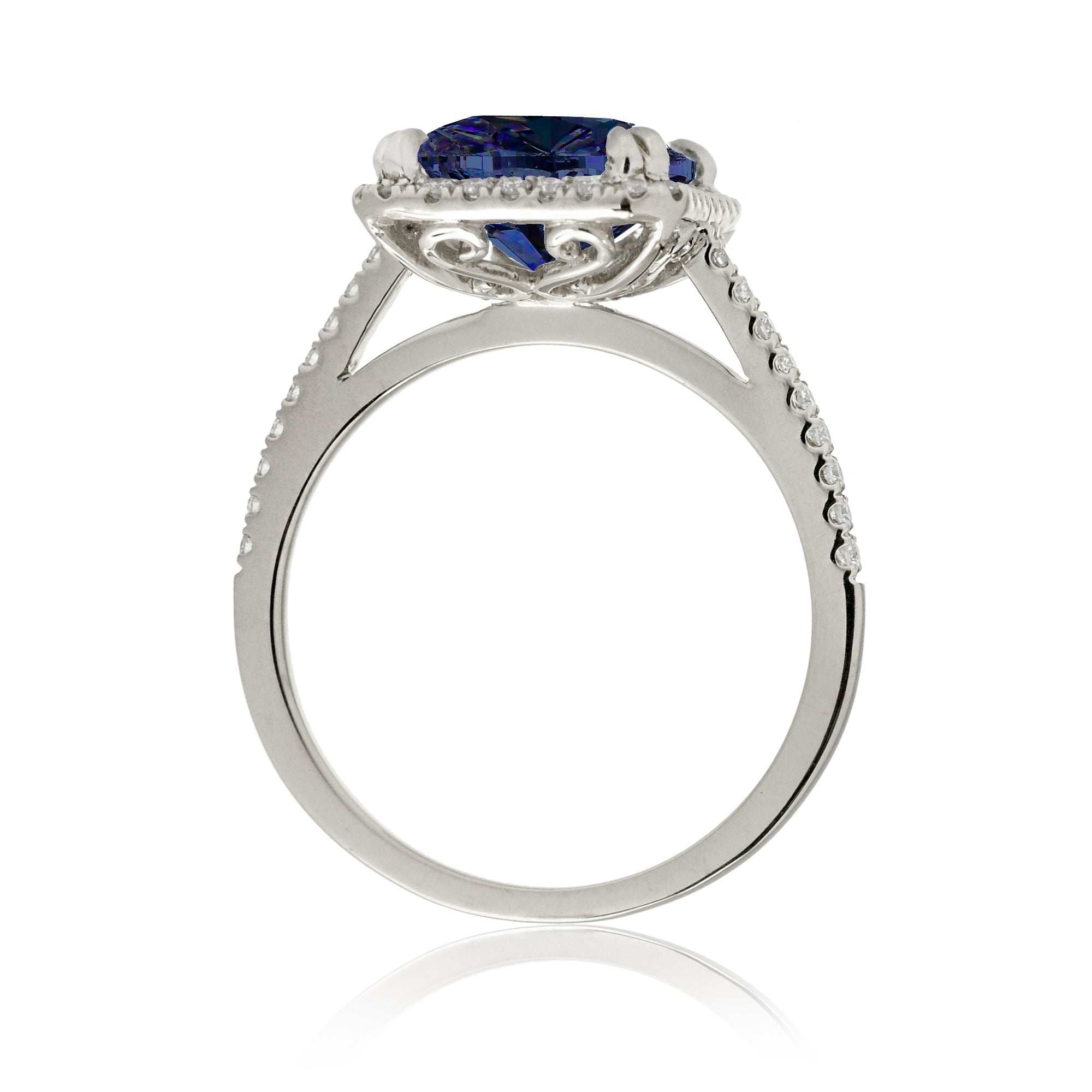 Emerald cut sapphire engagement ring with a diamond halo in white gold