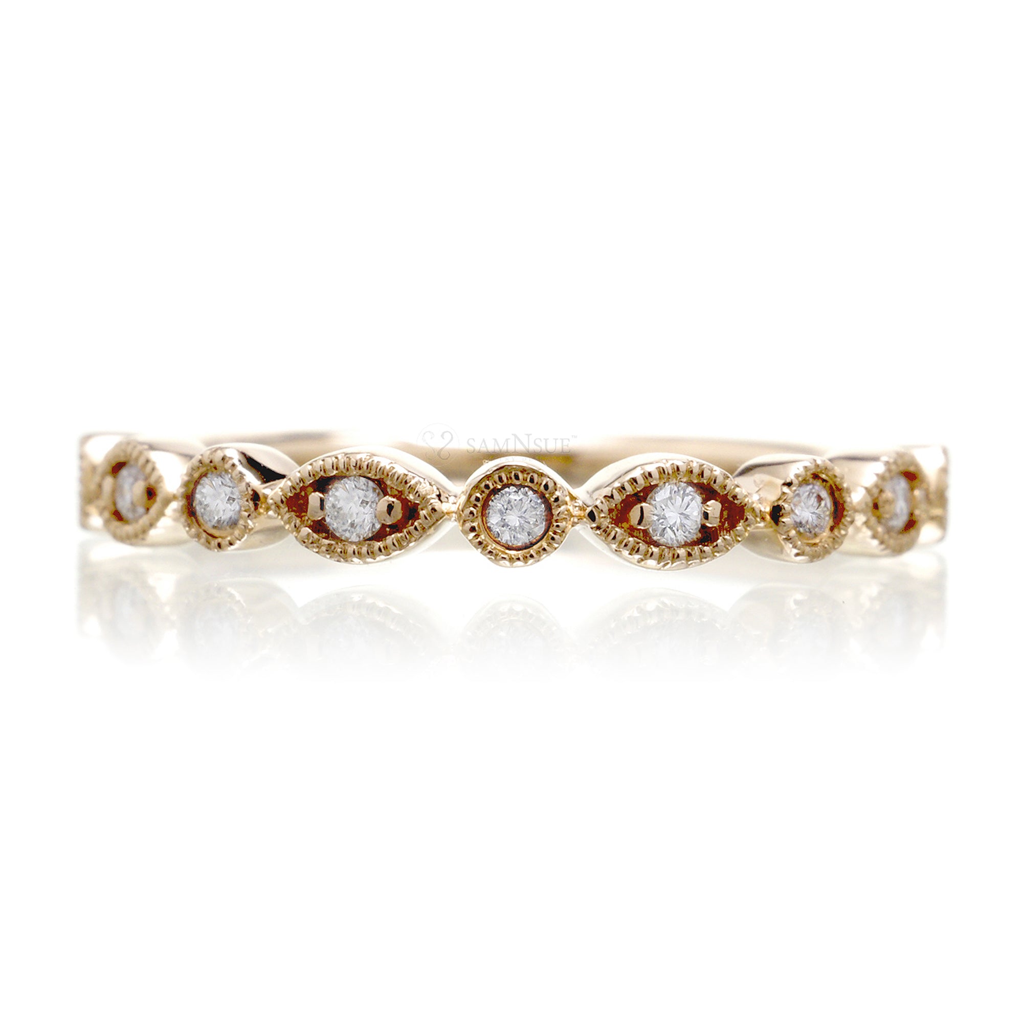 Yellow gold diamond band with marquise and round bezel settings