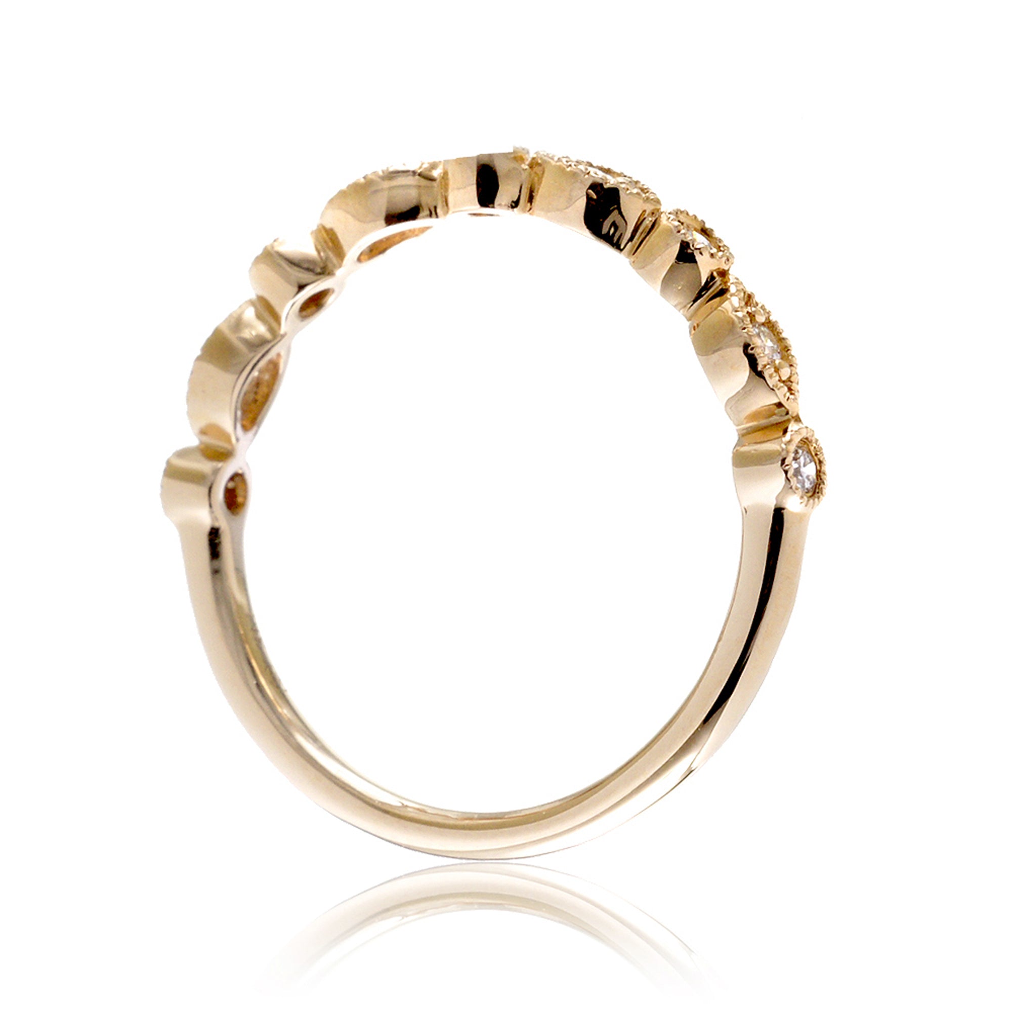 Yellow gold diamond band with marquise and round bezel settings