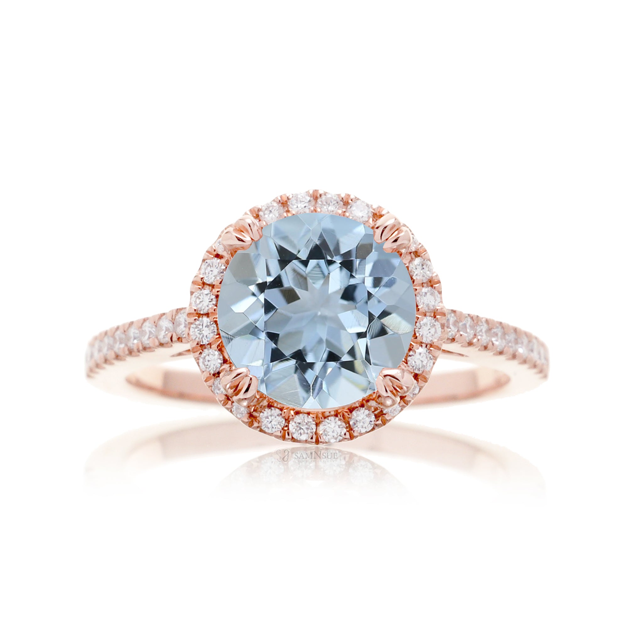Round aquamarine ring with a diamond halo and cathedral rose gold setting