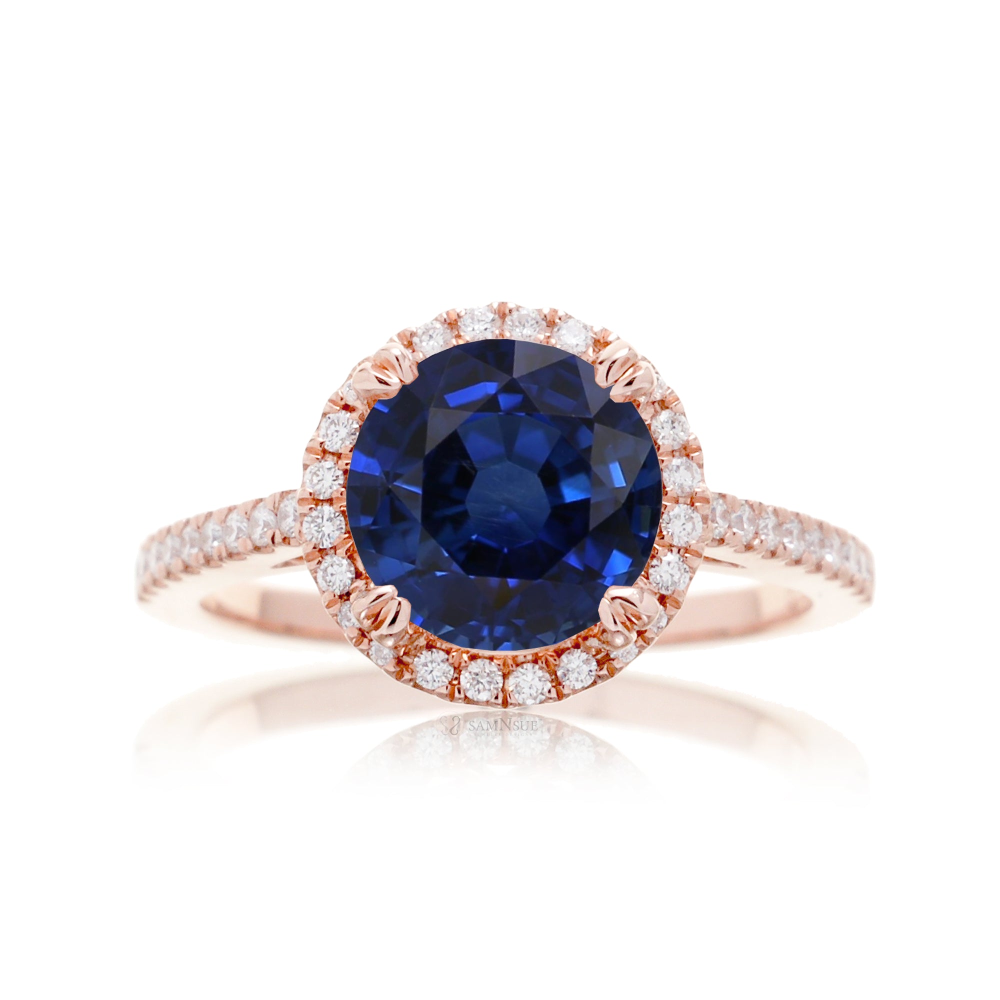 Round sapphire engagement ring with a diamond halo in rose gold