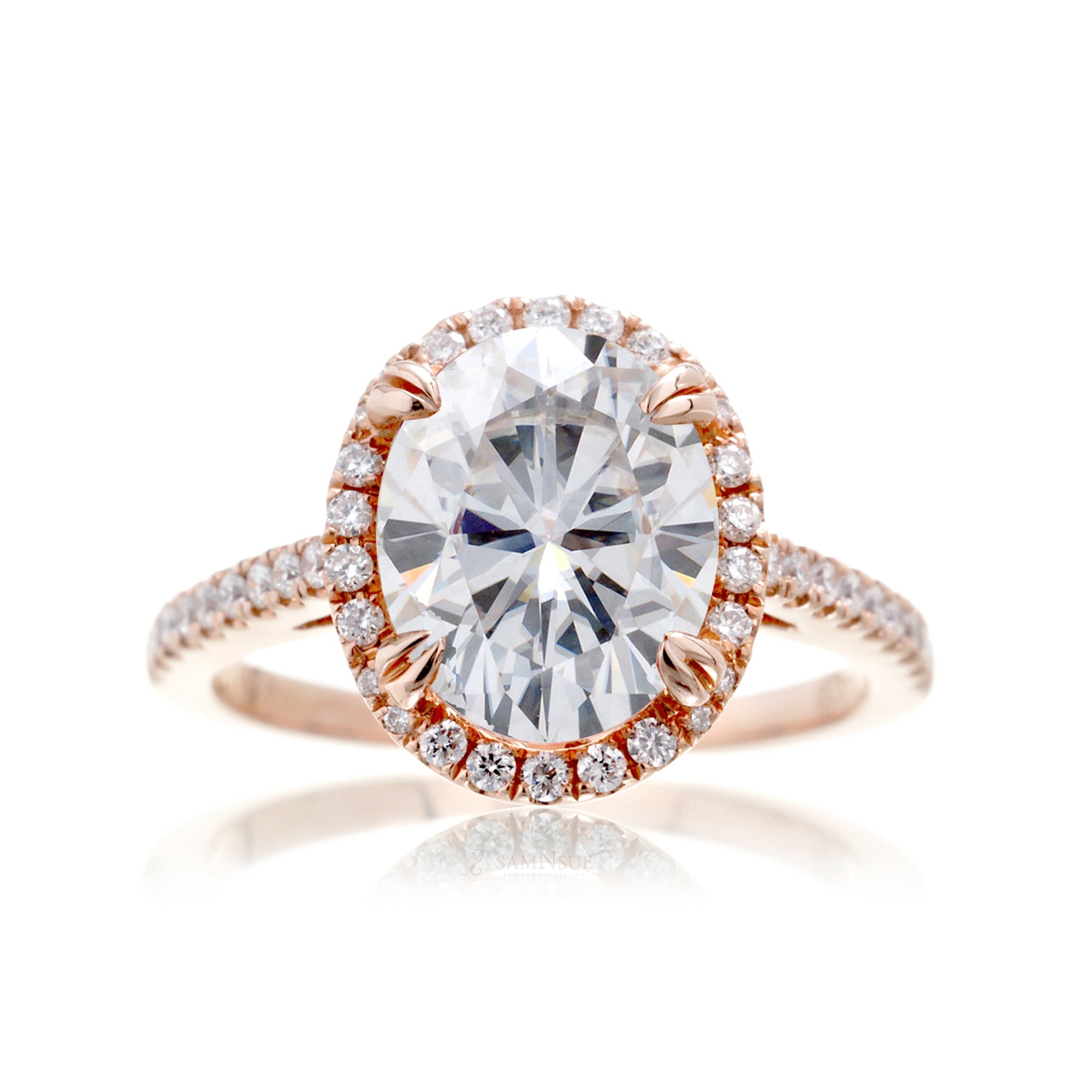 Oval cut moissanite engagement ring with a diamond halo in rose gold
