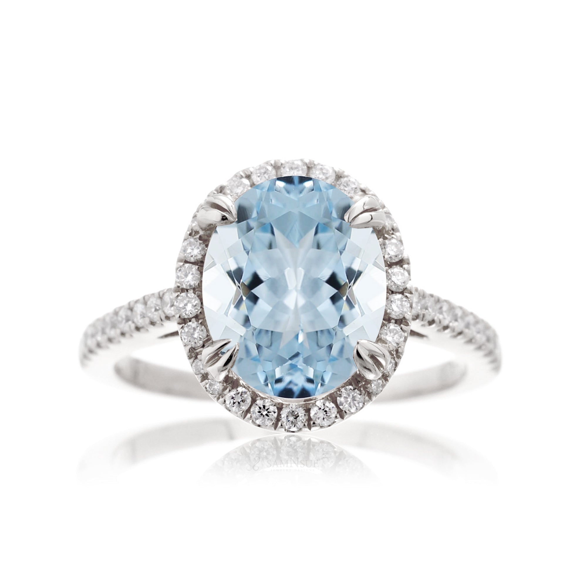 Oval cut aquamarine engagement ring with halo in white gold
