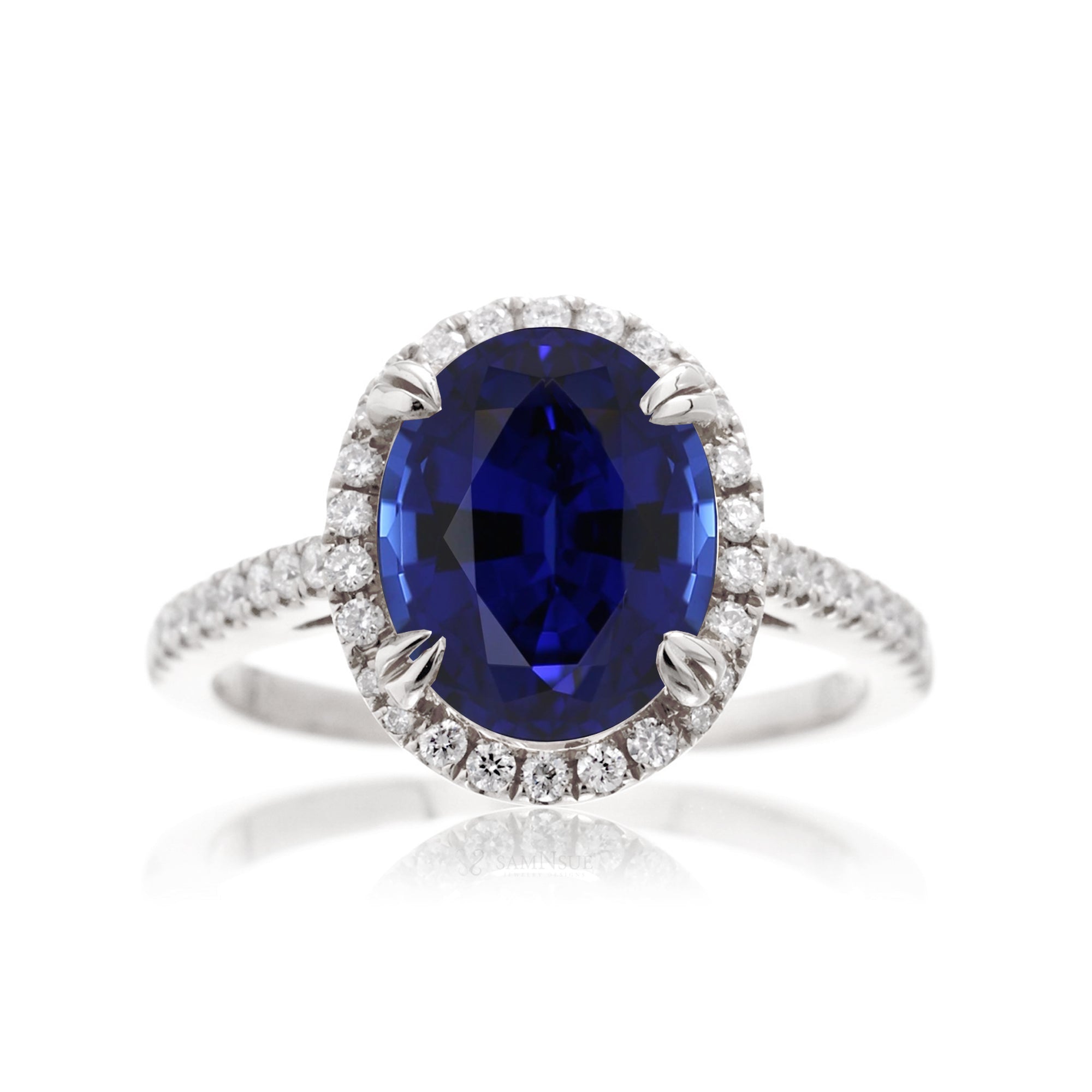 Oval shape blue sapphire ring with diamond halo in white gold