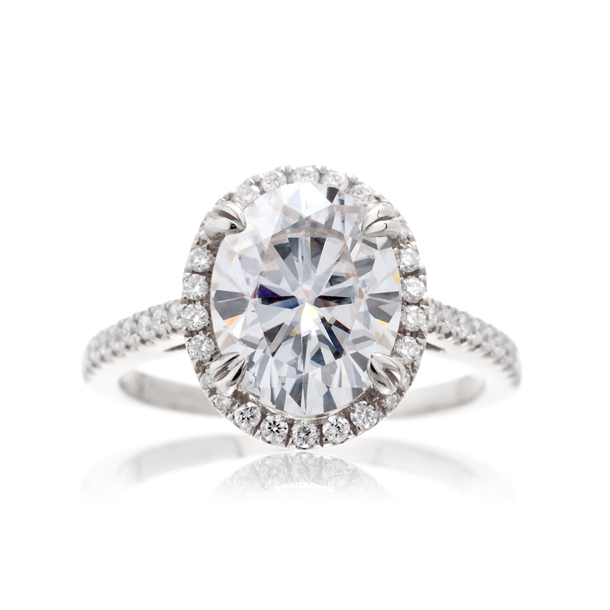 Oval cut moissanite engagement ring with a diamond halo in white gold