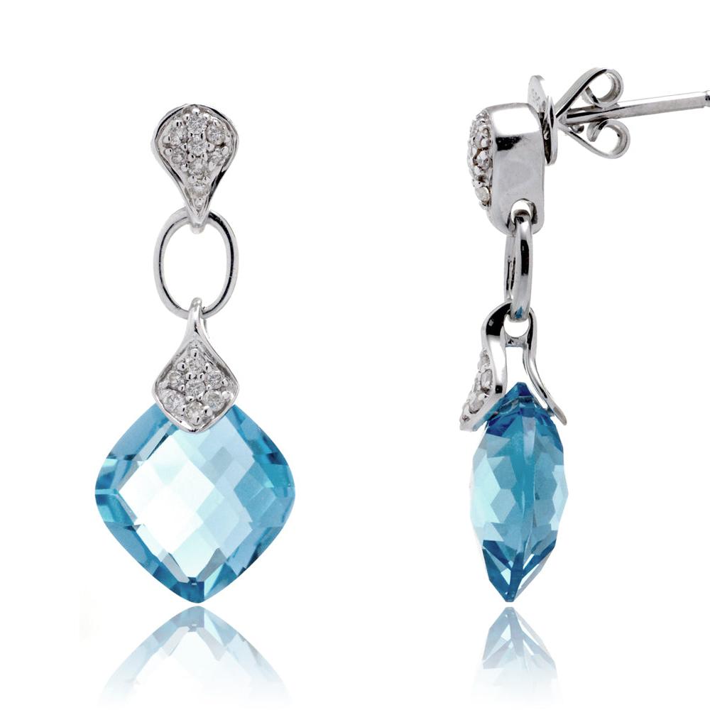 Pair of silver earrings with blue gemstones on a white background