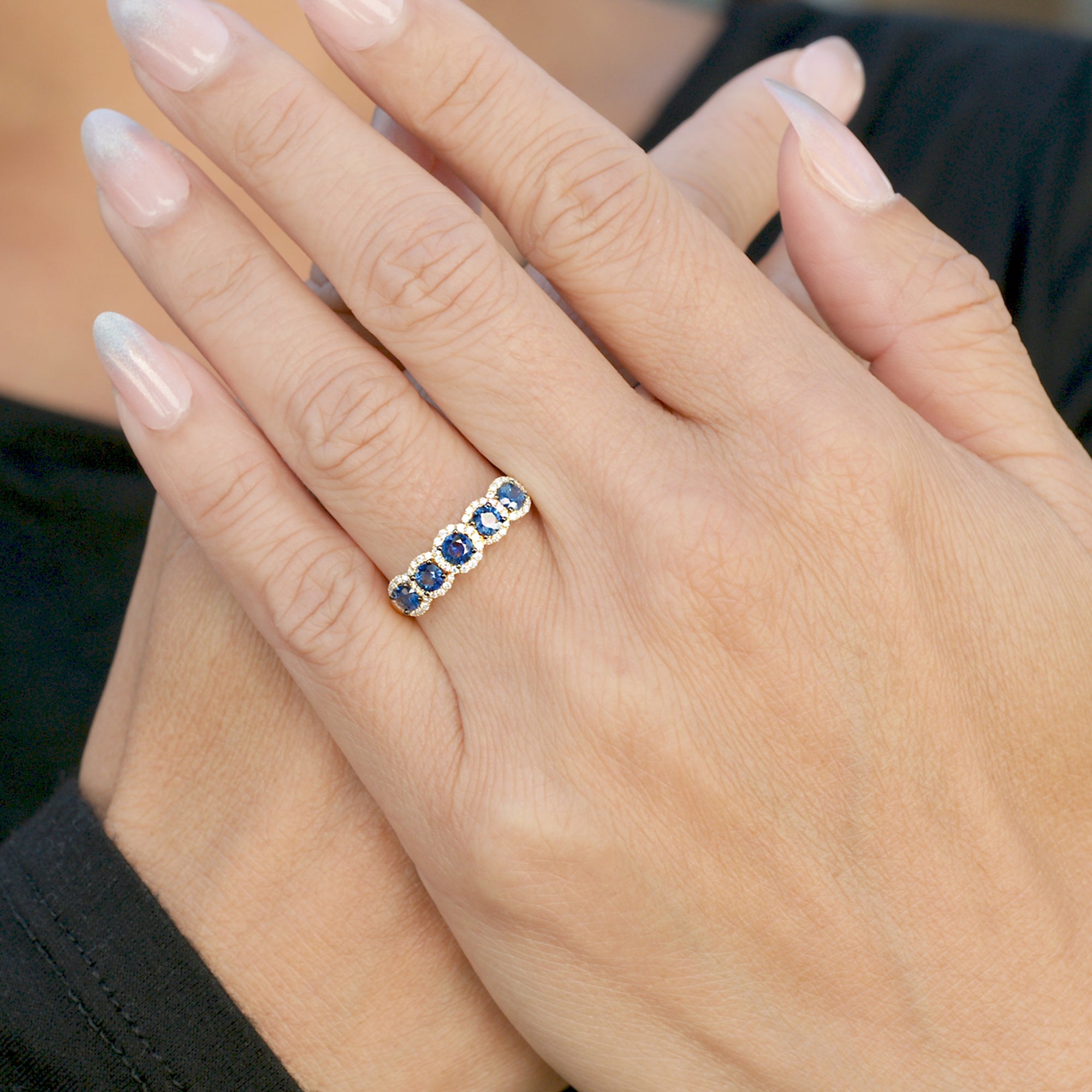 Five stone blue sapphire and diamond halo anniversary band in yellow gold