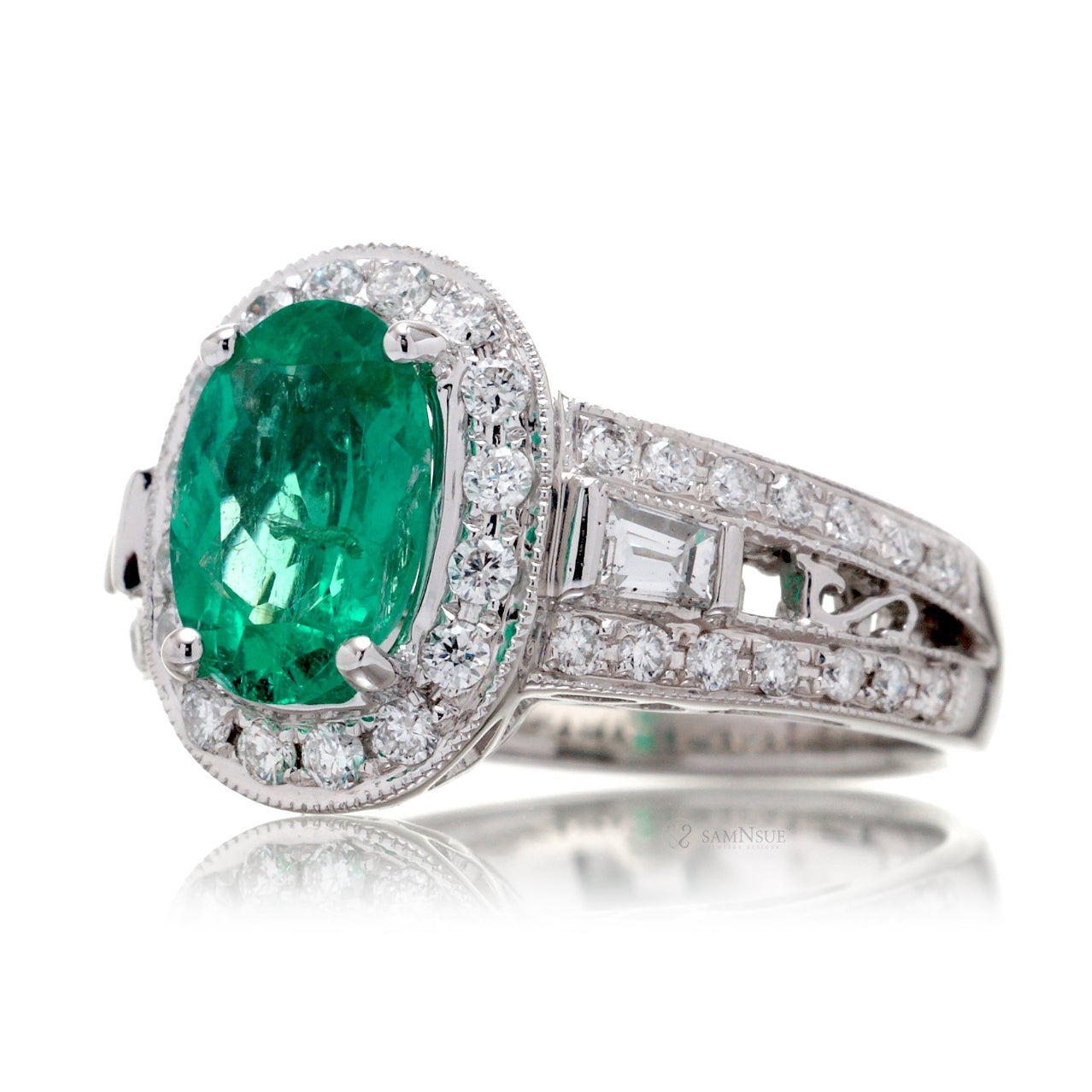 Emerald ring vintage style halo with milgrain and baguette on wide band in white gold