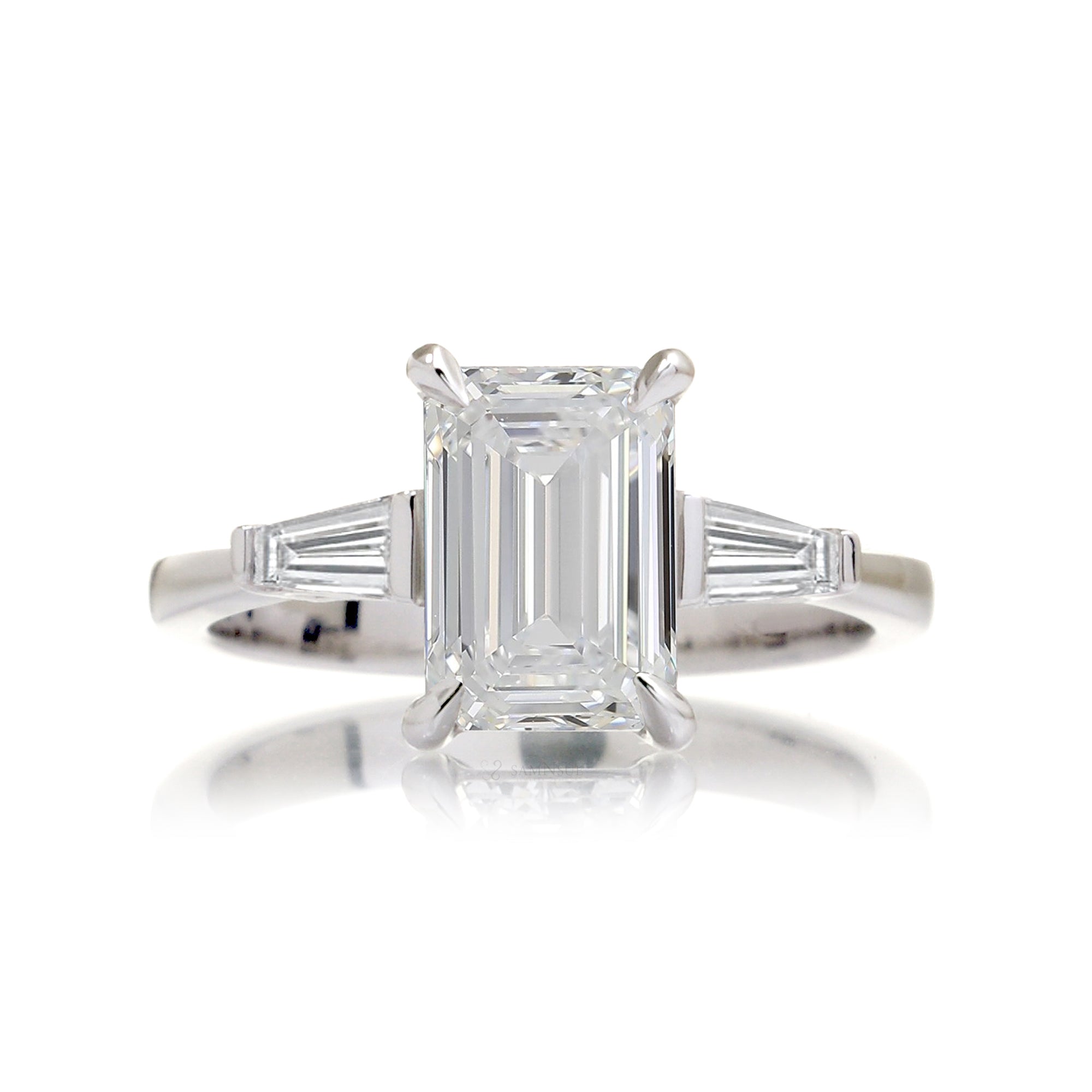Emerald cut diamond three stone baguette ring
