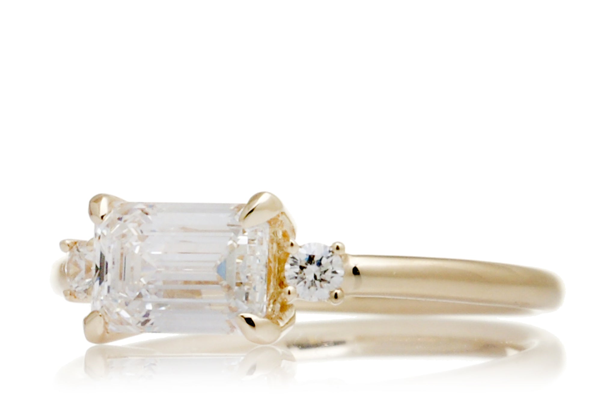 east-west emerald cut diamond three stone ring the Lena yellow gold