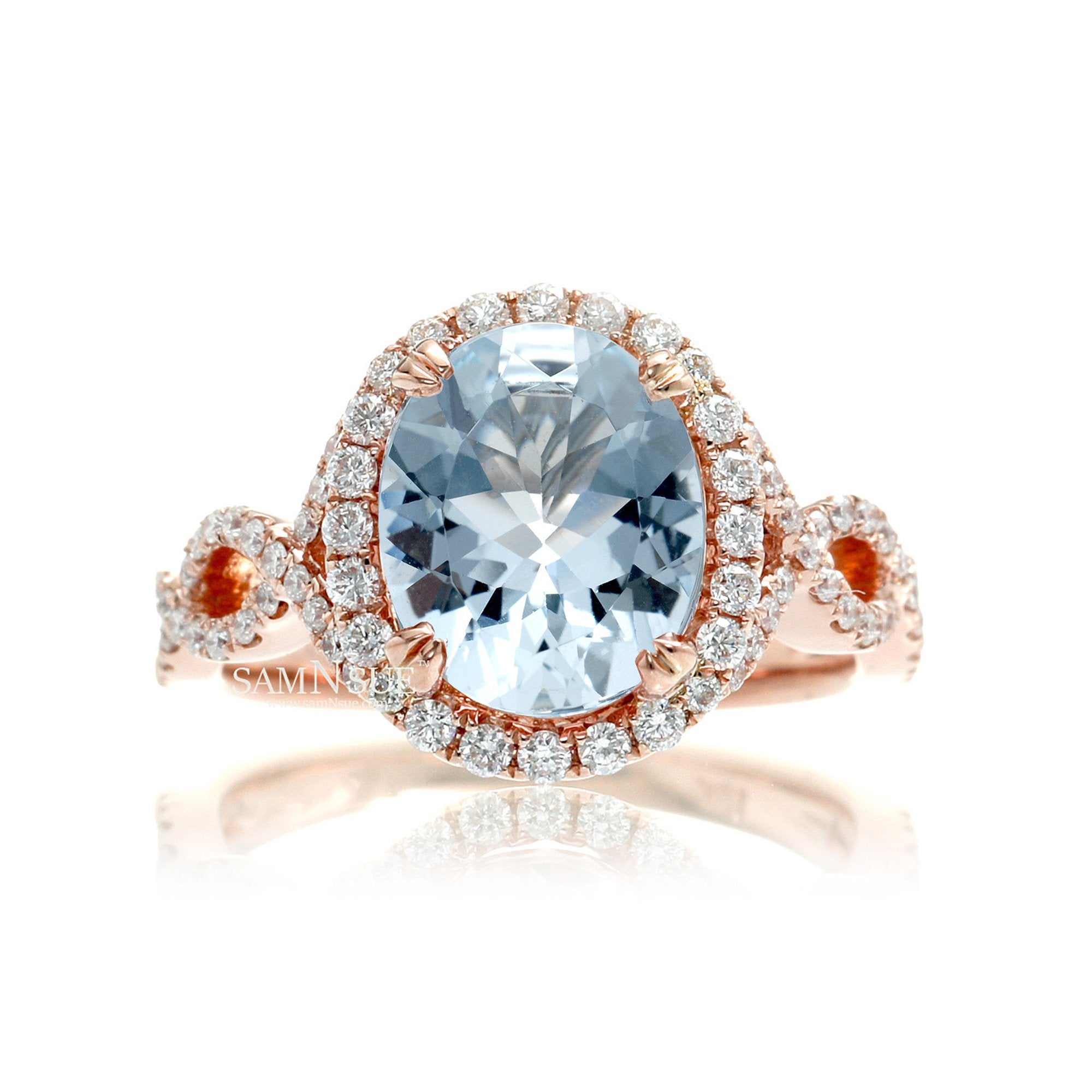 Oval cut aquamarine with diamond halo and twisted band rose gold
