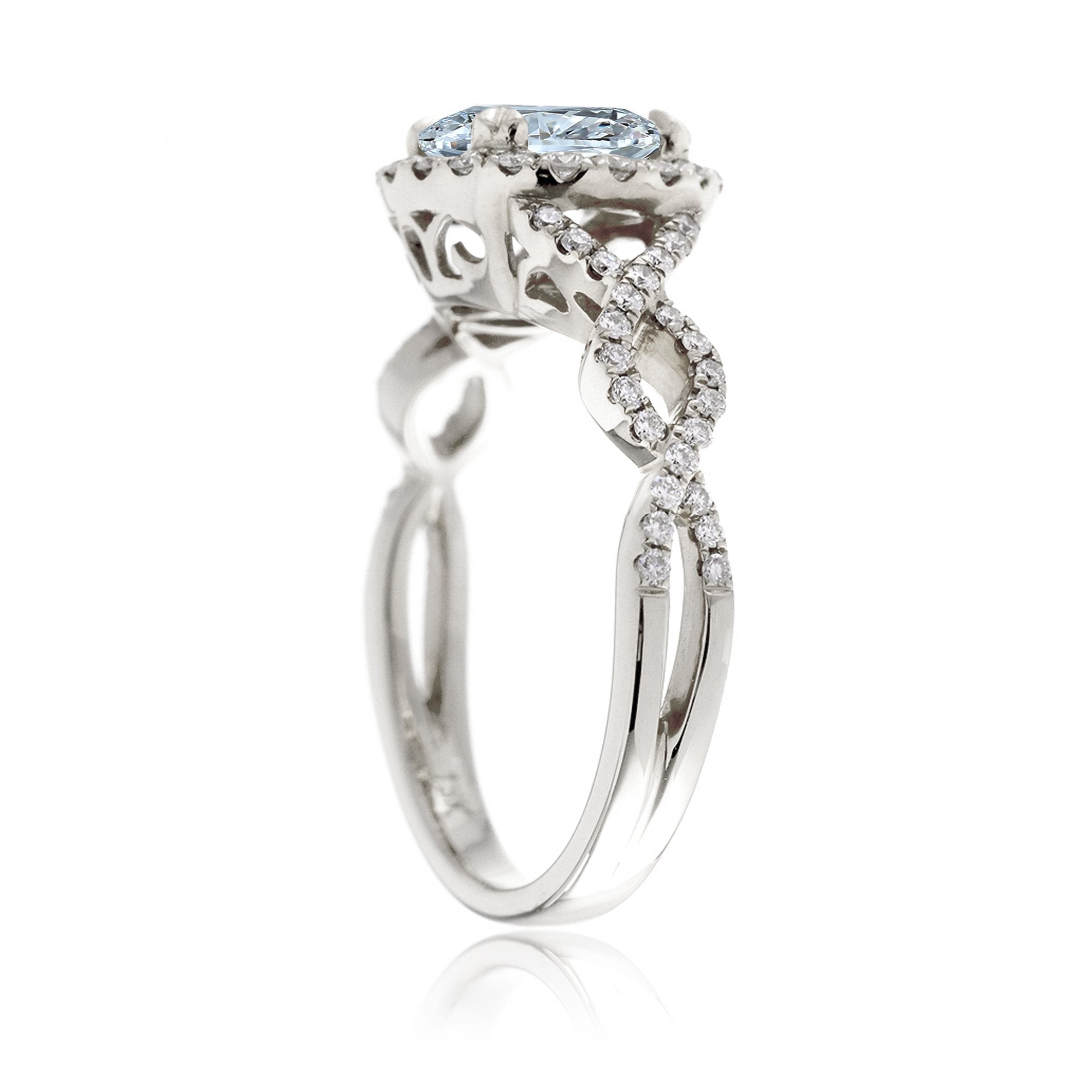 Oval cut aquamarine with diamond halo and twisted band white gold