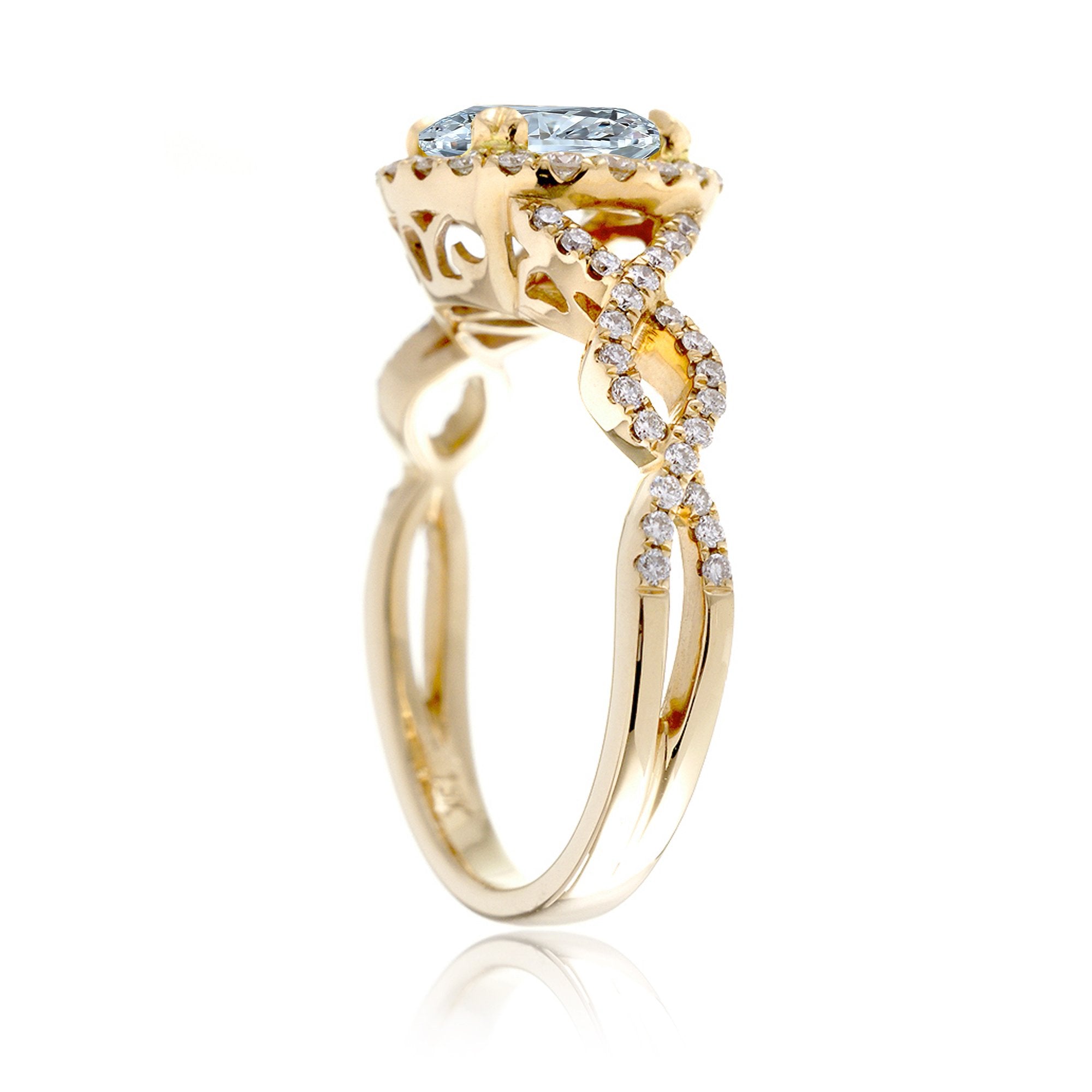 Oval cut aquamarine with diamond halo and twisted band yellow gold
