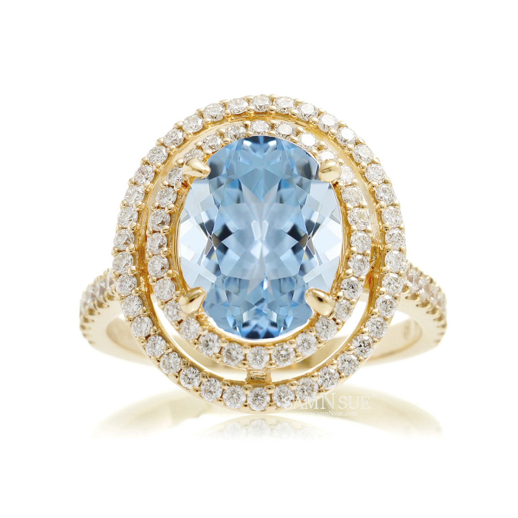 Oval cut aquamarine ring with double halo diamond band in yellow gold