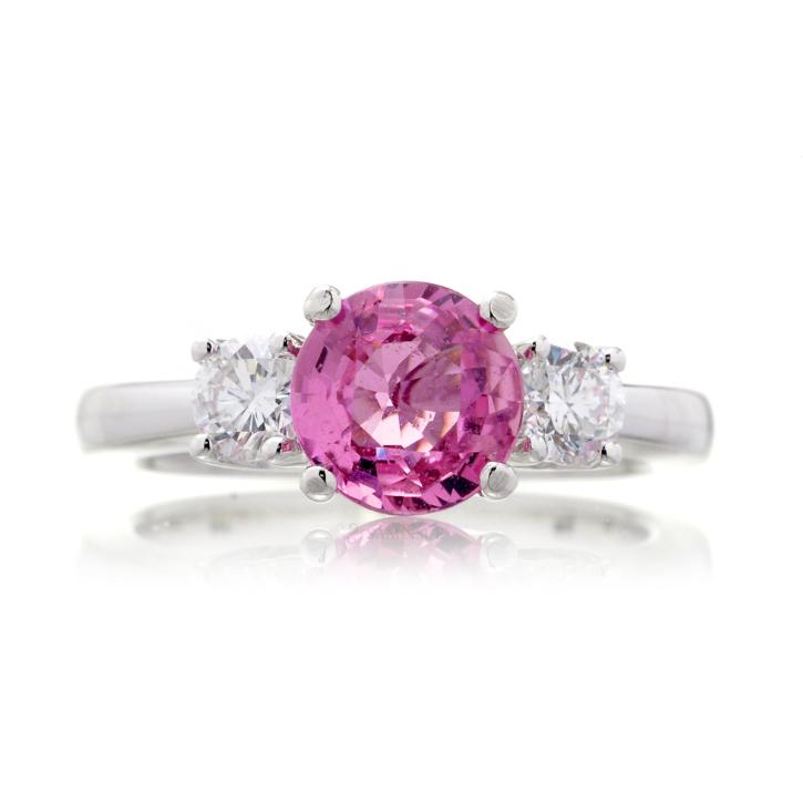 Pink sapphire round cut three stone engagement ring in white gold with solid band