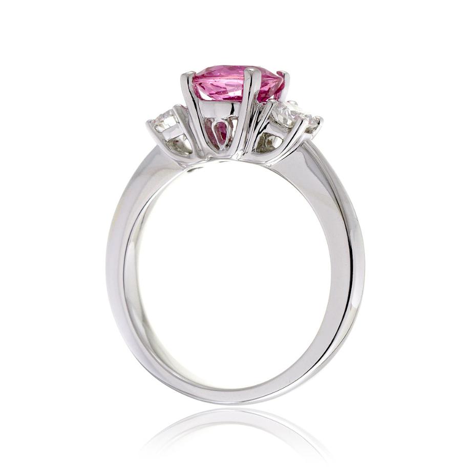 Pink sapphire round cut three stone engagement ring in white gold with solid band