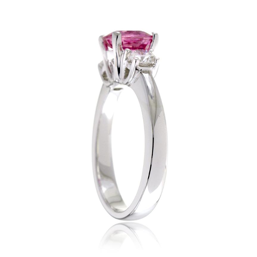 Pink sapphire round cut three stone engagement ring in white gold with solid band