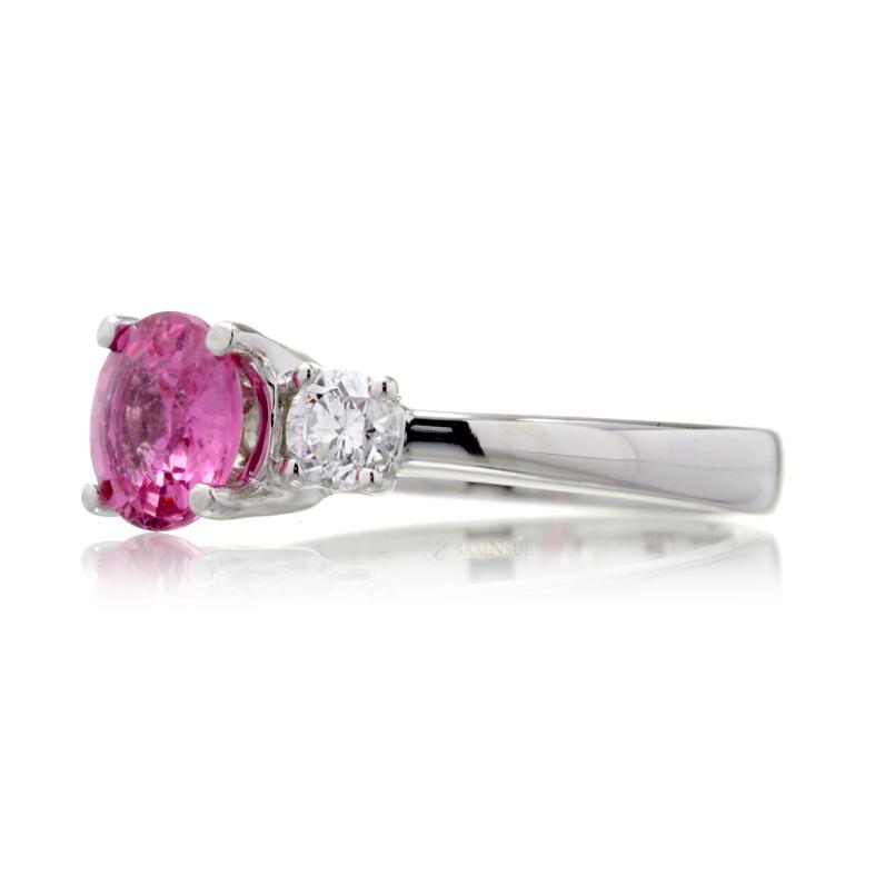 Pink sapphire round cut three stone engagement ring in white gold with solid band